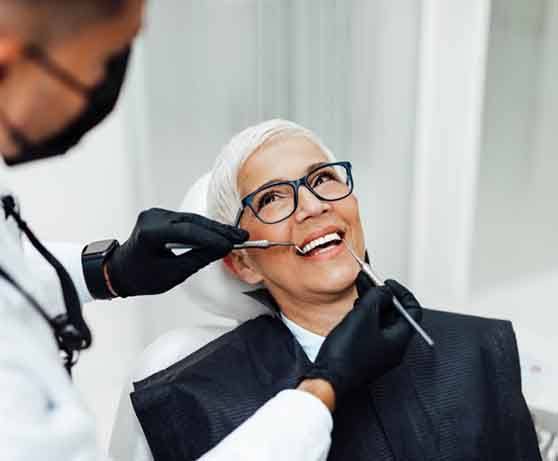 a patient getting her dental implants checked 