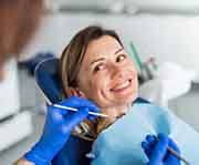 a patient smiling while getting her dental checkup