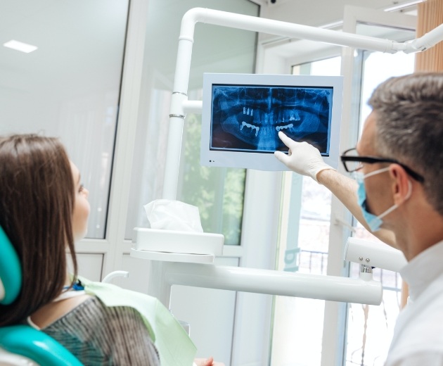 Oral surgeon and patient reviewing digital x-rays